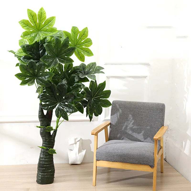 Kunstpflanze - Money Tree Kunstpflanze XXL / 130cm-150cm - Studio Verde neben einem modernen Stuhl in hellen Innenraum.